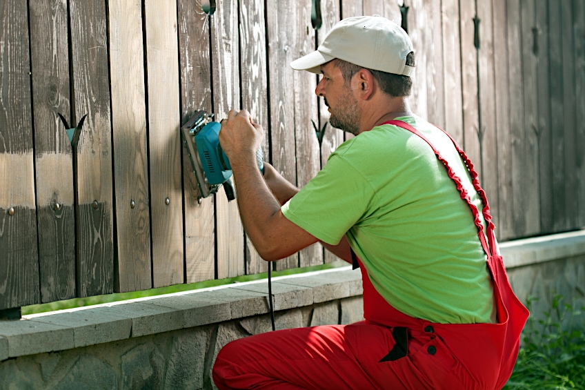 Using a Sander on a Wooden Fence